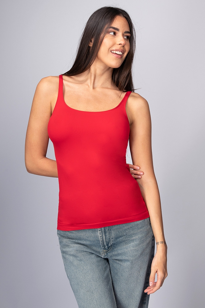 Woman wearing red camisole sitting near the house photo – Free